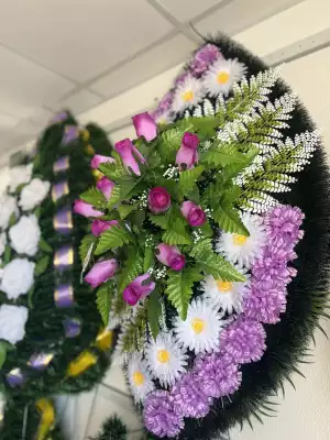 Венок с сиреневыми гвоздиками и розовыми бутонами
